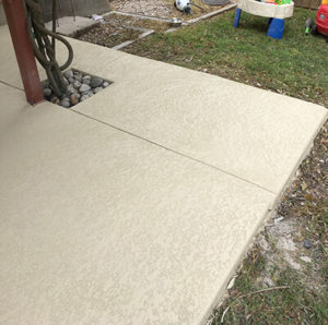 Concrete resurfacing over an outdoor ground outside an Austin, TX home.