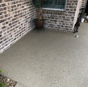 Mosaic patterned concrete refinishing in an Austin, TX home under shade.