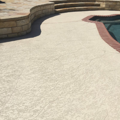 Concrete floor refinishing next to an outdoor pool in a home in Austin, TX.