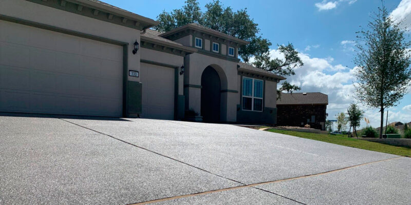 Results of our concrete driveway resurfacing outside an Austin, TX home under the sun.