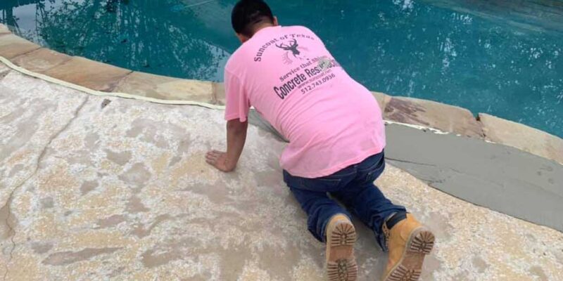 Residential concrete repair work in a home in Austin, TX, under progress by pool-side.