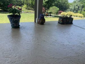Concrete patio coating and the backyard landscaping in an Austin, TX home