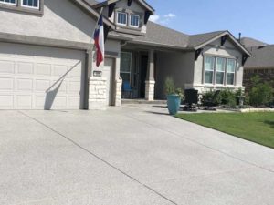 The results of our driveway resurfacing outside an Austin, TX home, under the sun.