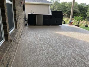View on a backyard of an Austin, TX home after professional patio refinishing