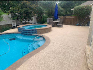 View on the backyard after the concrete pool and hot tub resurfacing in Austin, TX.