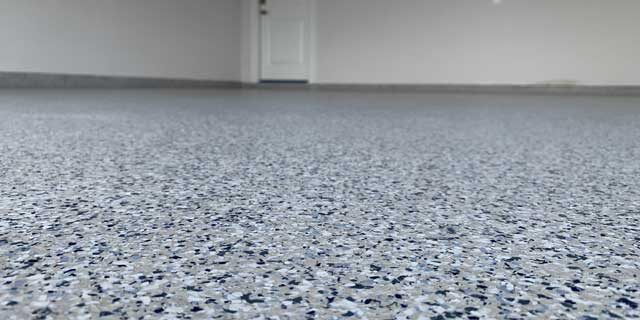An image of flooring in a garage; garage floor coatings can transform your home with new colors.