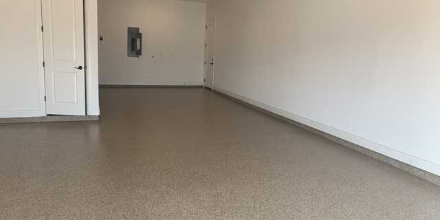 An image of a garage, garage floor coating cost varies according to the size of space and condition.