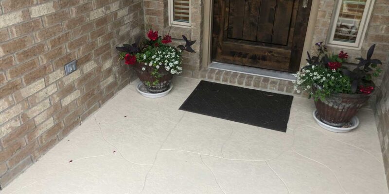 A stamped custom concrete coatings on a floor leading to the front door.