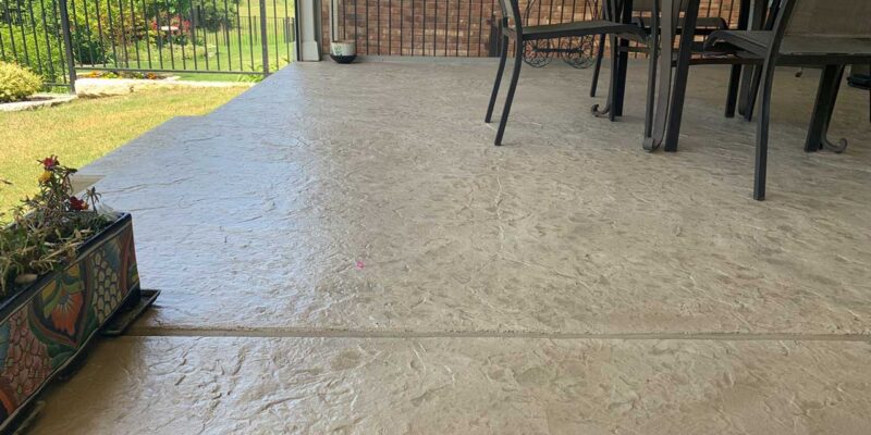 A porch with floors that have undergone stamped concrete resurfacing.