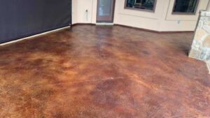 The outdoor patio with a beautifully stained concrete floor in a warm and earthy tone.