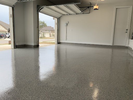 The freshly placed epoxy flooring in the garage transformed the space into a stylish area.